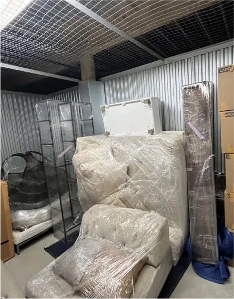 Storage unit with a wrapped sofa, cabinet and boxes