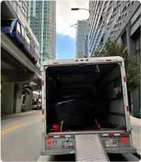 Open moving truck with ramp on a downtown Miami street